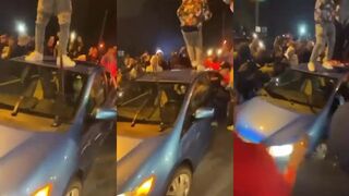 Mob of thugs surround car, destroy it