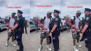 Man holding toddler gets in cop's face