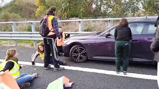 Protesters block street, but man driving doesn't really care