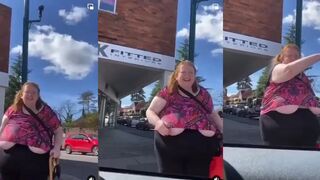 Woman's shirt has a little malfunction, but she doesn't seem to notice