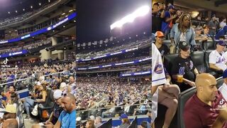 Dudes hold up giant Lets Go Brandon flag at baseball game